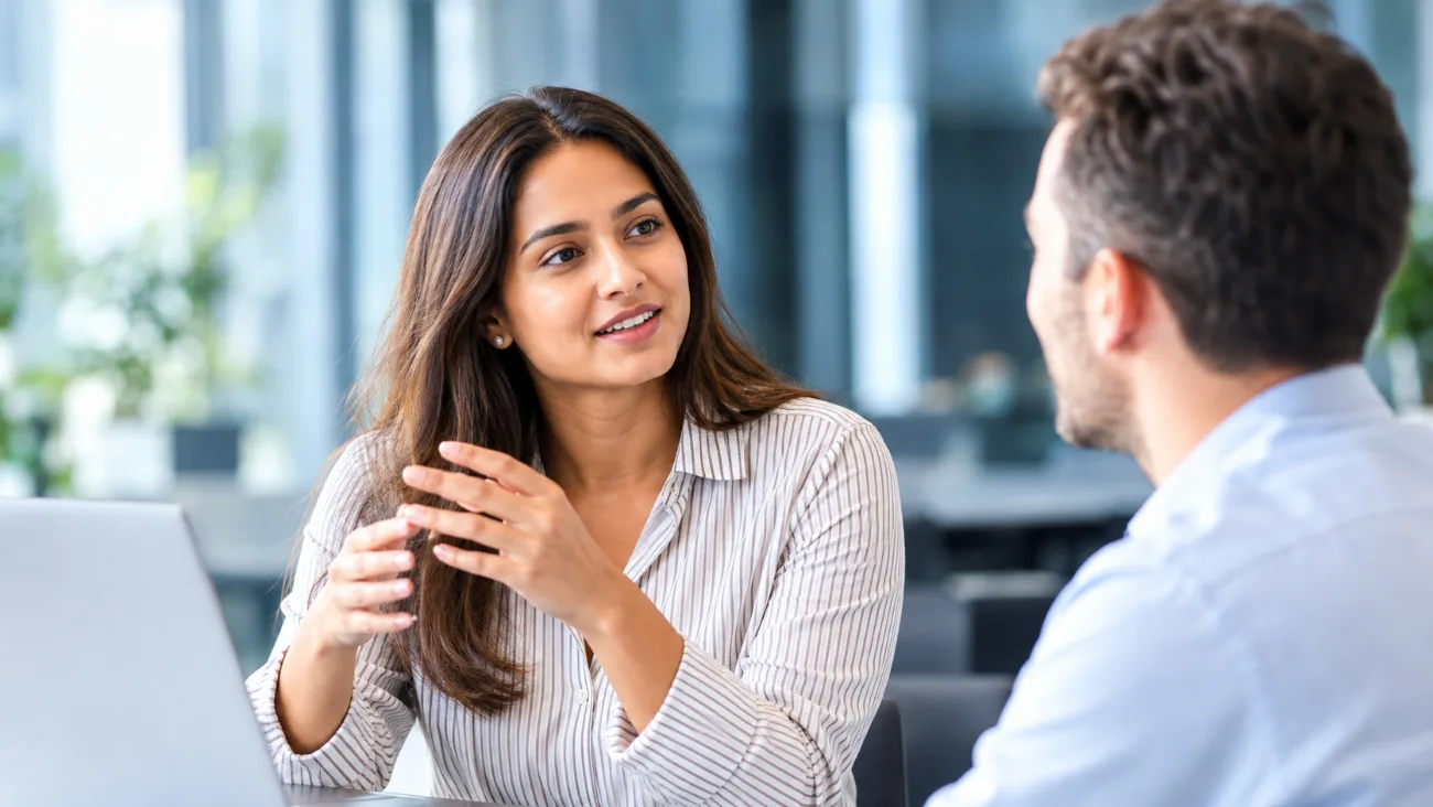 A GSS advisor discussing a program with a colleague in a bright office